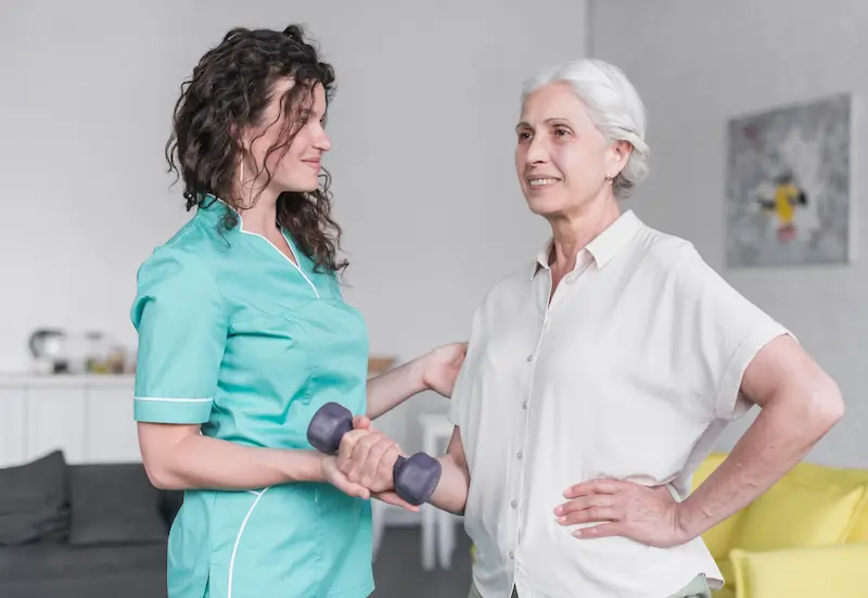 beautiful-old-lady-is-doing-exercise-with-dumbbell-with-help-physiotherapist